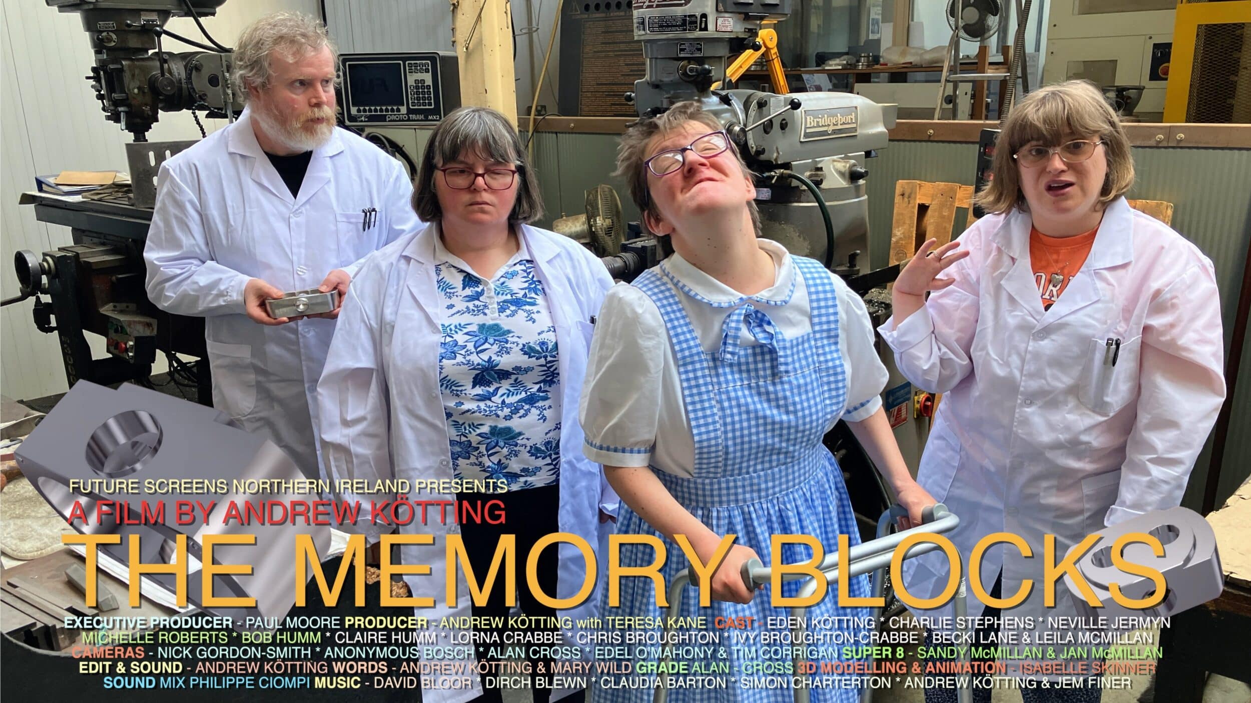 A promotional photo from the film The Memory Blocks, by Andrew Kötting. Neville Jermyn, Michelle Roberts and Charlotte Stephens stand in a row in white lab coats. Eden Köttin wears a blue and while gingham dress, like Dorothy from the Wizard of Oz, and holds onto a stroller.